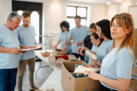 Group volunteers sorting donations for community charity work