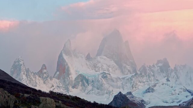 Clouds moving over the Mt Fitz Roy peak glowing in sunrise light, Patagonia