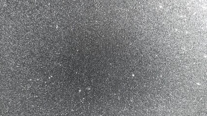 Fototapeta premium Close up abstract shiny silver glitter background with bright glowing sparkle particles. Glittering silver texture surface with elegant shimmer effect. Blank shiny silver glitter texture background.