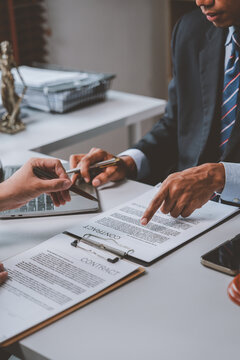 Lawyers discussing contract details and legal agreement