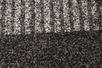 Seamless generic carpet fabric pattern background texture. Geometric abstract pattern. Close up of tufted surface with black and grey combination © andi