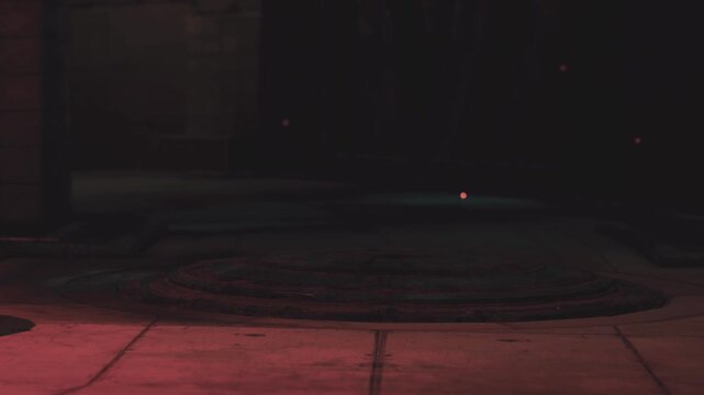 A city street scene takes place during the night. Dim light illuminates parts of the street while dark shadows create an uncertain atmosphere. The setting appears empty with no people.