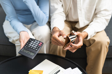 Fototapeta na wymiar Stressed financial owe asian young couple love sit suffer, stressed and confused by calculate expense from credit card at home, no money to pay, mortgage or loan. Debt, bankrupt or bankruptcy people.