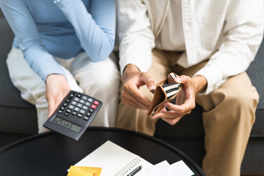 Stressed financial owe asian young couple love sit suffer, stressed and confused by calculate expense from credit card at home, no money to pay, mortgage or loan. Debt, bankrupt or bankruptcy people.