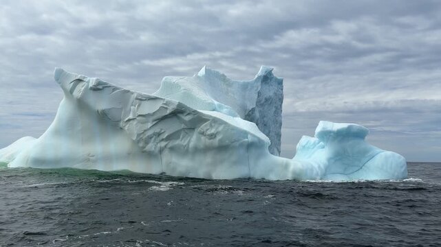 Majestic iceberg floating on a choppy ocean off coast of Newfoundland