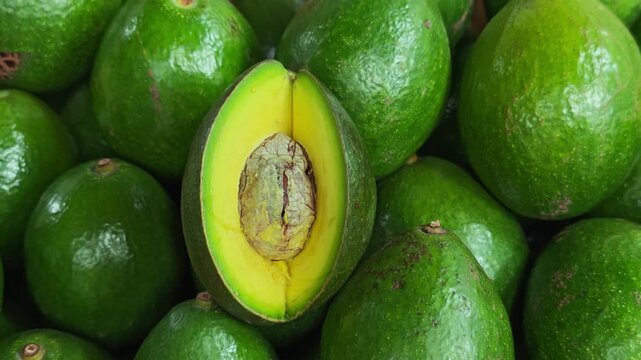 Fresh green avocados in a basket.