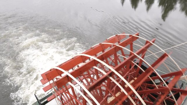 a close up shot of the wheel of a paddleboat sailing on the chena river near fairbanks, alaska of the usa