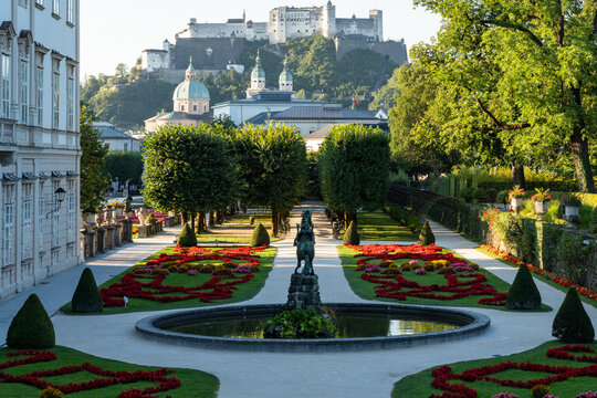 Formal Garden With Fountain, Trees and Hilltop Fortress