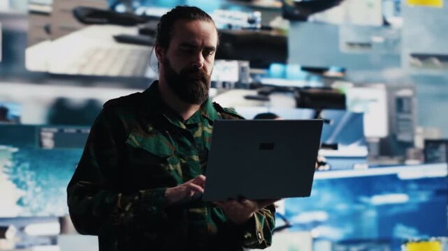 Military officer evaluates surveillance data and electronic threat detection systems to coordinate tactical operations and technology driven mission control.
