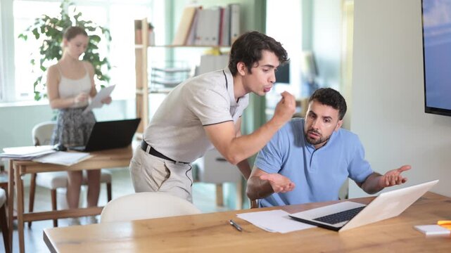 Businessman scolds his employee man sitting at workdesk in the office. High quality 4k footage