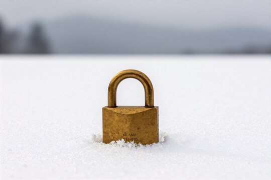 A vintage padlock on fresh snowfield