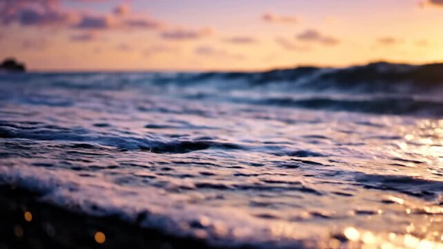 Close up of a dramatic ocean wave crashing onto a dark pebbled beach at sunset with warm golden light reflecting on the wet stones, tranquil atmosphere