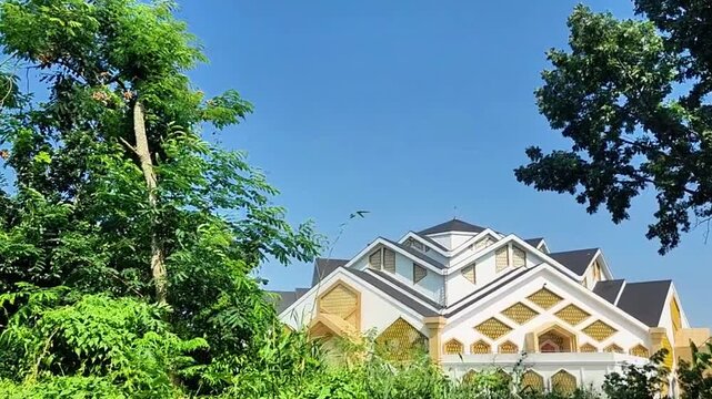 A shot of the Tsamarul Insan Mosque&mdash;located within the Jambi Islamic Center near Sultan Thaha Airport and the Jambi Zoo&mdash;framed by lush, shady trees.