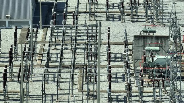 Aerial view of a high-voltage utility substation, emphasizing critical energy infrastructure, intelligent grid management, efficient power flow, and future-ready electrical distribution networks. 4k.
