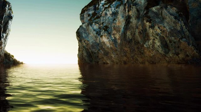 The sun sets between two rocky cliffs at the sea. Water flows quietly in the area, and the light reflects off the surface, creating a calm scene at dusk.