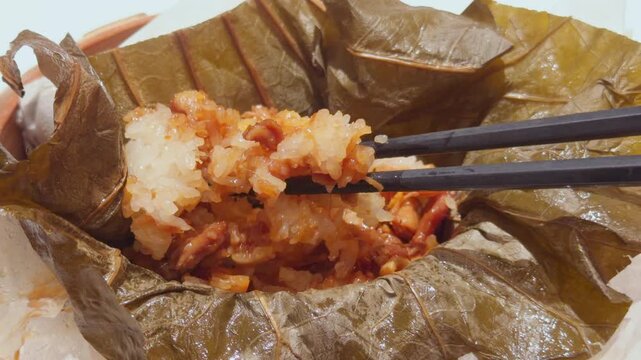 Cantonese Lo Mai Gai Lotus Leaf Sticky Rice Chicken Chopsticks Lifting Close-Up