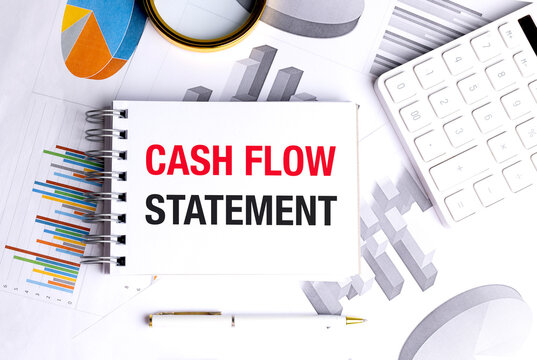 Cash flow statement concept with financial reports calculator notebook and business charts representing corporate