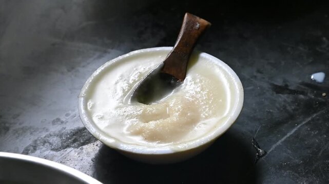 pure desi ghee in wooden bowl on black background