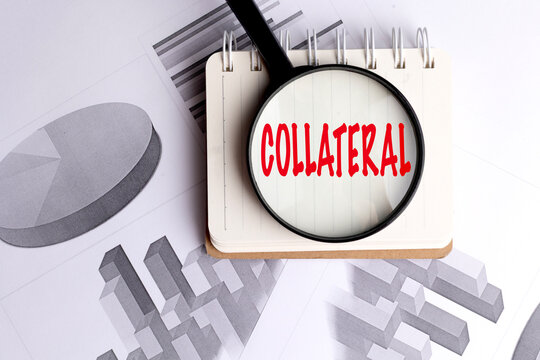 Collateral concept with magnifying glass notebook and financial charts representing secured lending asset backing loan