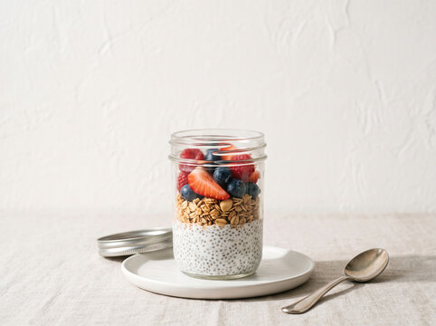 Chia seed pudding with granola and fresh berries in a jar