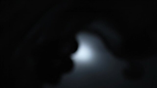 Darkness with a small beam light.