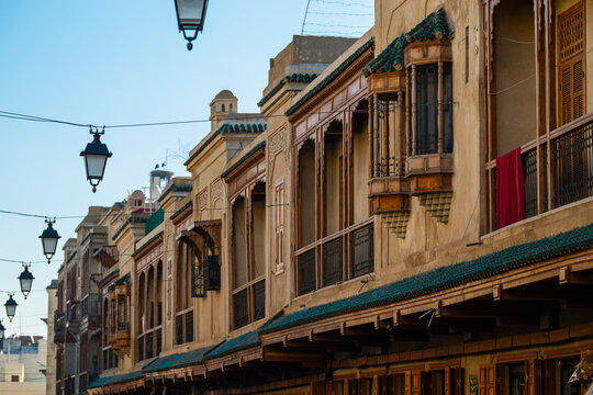 Traditional Moroccan buildings with ornate balconies and streetlights