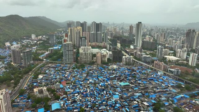 Urban development contrast in Mumbai city drone shot Mumbai cityscape showing slum and high rise buildings aerial view