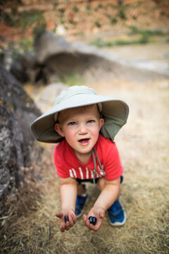Curious toddler exploring nature finds some treasures