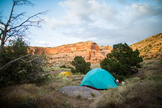 Two camping tents pitched in a remote canyon