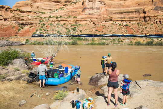 Family on river trip stops to watch train pass