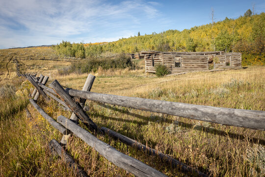 Abandoned Log Cabin and Split Rail Fence in Autumn Prairie Lands