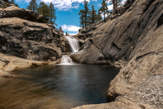 Silky waterfall flows into a granite rock pool