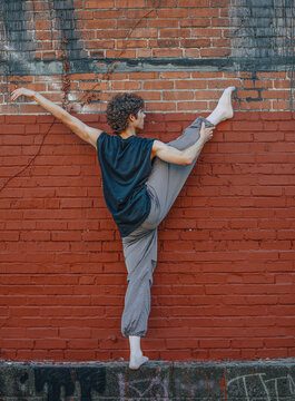 Young male dancer doing a standing split stretch