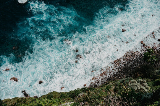 Turquoise ocean waves crashing on a rugged coast