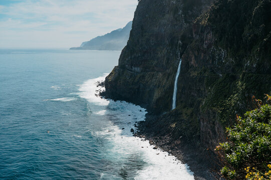 Wide coastal view of V&eacute;u da Noiva waterfall on Madeira Island