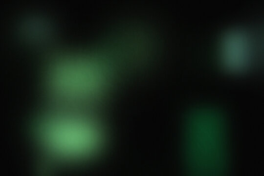 Green bokeh lights on black background