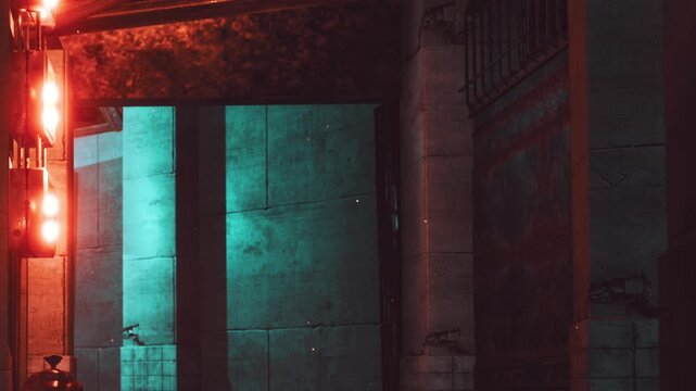 A city street shows a quiet scene at night. Bright neon lights illuminate a corner. The area appears empty, highlighting the contrast between light and shadows.