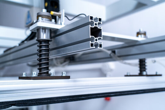 Aluminum extrusion profiles and springs on an industrial machine in a factory setting