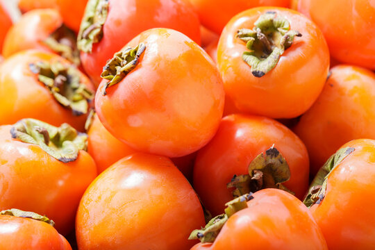 close up of fresh ripe persimmon fruit as background