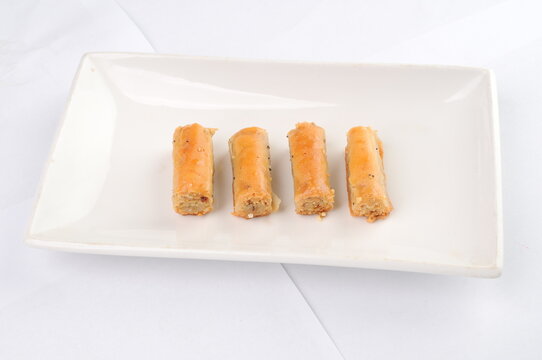 Four Pieces of Baklava Arranged on a White Plate