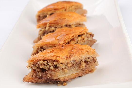 Four Pieces of Baklava Pastry on a White Plate