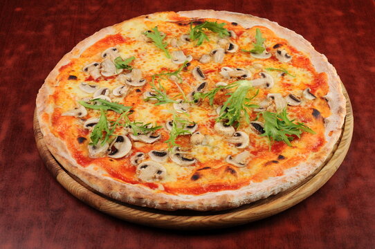 Mushroom and Arugula Pizza on Wooden Board
