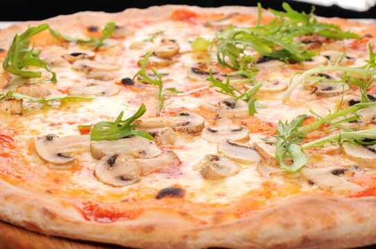 Mushroom and Arugula Pizza on Wooden Board