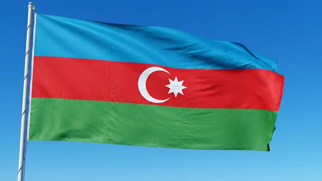 Waving flag of Azerbaijan with blue red and green stripes and a white crescent and star, national symbol blowing in the wind against clear sky