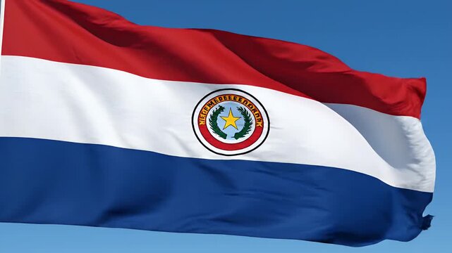 Paraguay national flag waving in clear blue sky, patriotic symbol with emblem and stripes, representing nationhood and freedom