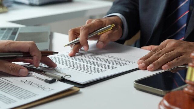 Lawyer advising client on business contract agreement