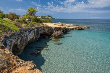 Fototapeta premium Stunning view of a pristine white sand beach in Kefalonia, Greece. Surrounded by dramatic limestone cliffs and crystal-clear turquoise Ionian water.