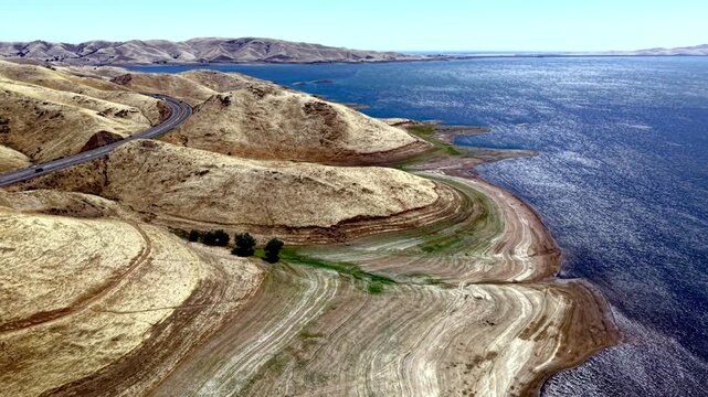 aerial push down the shoreline of the san luis reservoir