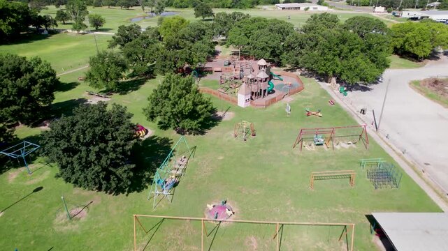 Aerial view of Enid Justin Park in Nocona, Texas. Camera is flying approximately west.