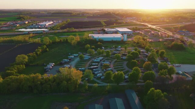 The day's last warm light drifts across rows of parked RVs &mdash; a peaceful portrait of travelers settled in for the night somewhere along the American interstate. Deforest Wisconsin